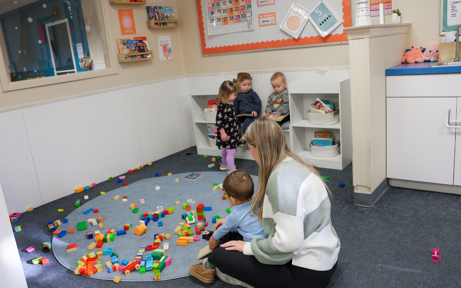Young toddlers developing coordination through hands-on classroom activities